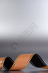 胶片脱条螺旋漩涡空白模拟卷轴相机棕色灰色艺术幻灯片背景图片