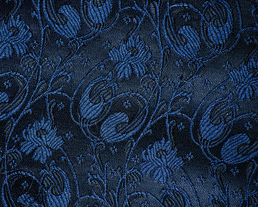 陈年花样的卷纹织物细节蓝色花朵奢华挂毯丝绸材料漩涡缝纫黑色古董背景图片