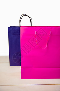 购物礼品袋粉色零售木头蓝色紫色展示礼物背景图片
