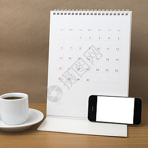 咖啡杯 电话和日历办公室桌子笔记杯子笔记本白色商业铅笔工作咖啡背景图片