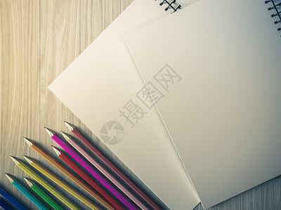 在木材背景上检查过的笔记本上的彩色铅笔夹子办公室学校木头塑料活页笔记教育网格金子背景图片