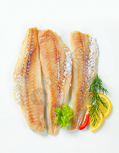 白鱼片鳕鱼鲶鱼食物库存鱼片白鱼柠檬高架熏制煤鱼背景图片