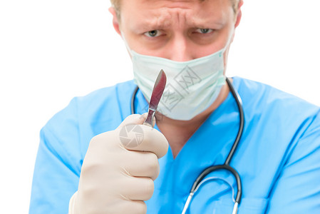 精神紧张的外科外科医生 用手术刀脸部不专注医院高清图片素材