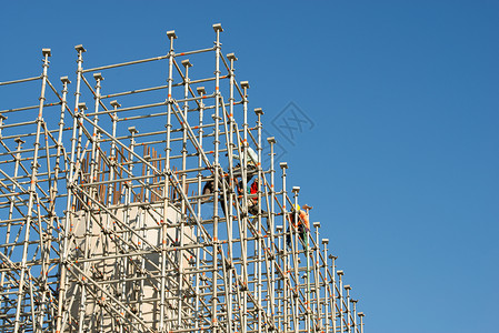 建筑工地工人财产公寓工程对角线脚手架劳动商业建筑物进步水泥格子高清图片素材