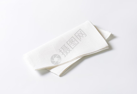 白布巾纸餐巾纸白色织物餐垫纺织品桌布餐巾折叠背景图片
