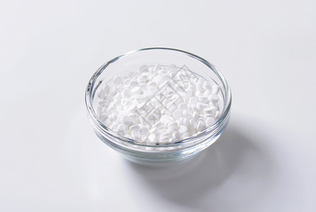 人造甜甜剂平板糖精药片热量白色玻璃食品背景图片