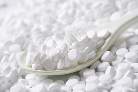 人造甜甜剂平板热量食品药片画幅糖精勺子白色背景图片