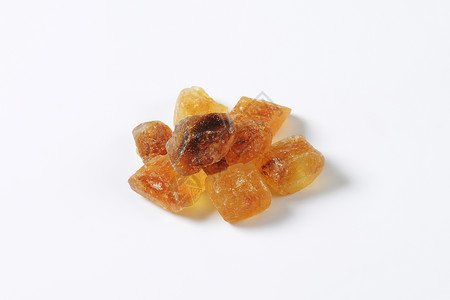 褐岩糖晶体棕色团体食物味道糖果肿块焦糖水晶高架琥珀色背景图片