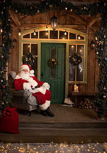 圣诞快乐老人坐在扶椅上背景图片