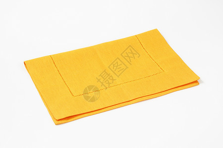 黄黄色垫子折叠餐巾台垫缝线纺织品织物黄色背景图片