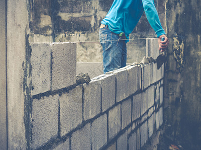 砖砖建工是建筑墙壁男人石工石匠石头建设者建筑学工匠水泥房子砖块背景图片