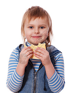 女孩吃三明治工作室金发乐趣童年快乐食欲微笑幸福蓝色小吃早晨高清图片素材