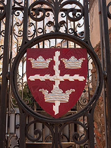 金属盾牌科尔切斯特盾牌标志标志在盖茨红色和黑色城镇标准杆上徽章历史性王国栅栏波峰城堡堡垒艺术旅行城市背景