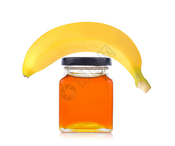 黄色蜂蜜液体白色背景的蜂蜜罐和香蕉液体甜点食物玻璃早餐水果营养黄色热带金子背景