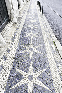 典型的里斯本石地板手工石头园林人行道街道路面地面鹅卵石对称全景背景图片