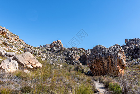 雅江到理塘的路上徒步登山路上的岩层形成到马耳他克罗蓝色旅游晴天爬坡巨石农村阳光小路远足旅行背景