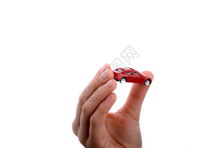 持有一辆红色车的儿童手运输驾驶人手汽车车辆交通保险背景图片