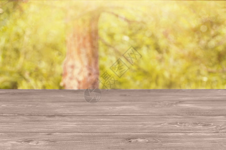 木制表格表面和模糊的黄绿色背景 模拟显示产品模版  label group背景图片