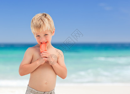 小男孩吃冰棒小男孩吃冰淇淋天空孩子假期乐趣男生海洋冰棒享受食物童年背景