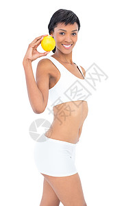 装着拿着橙子的有活力身材的女人背景图片