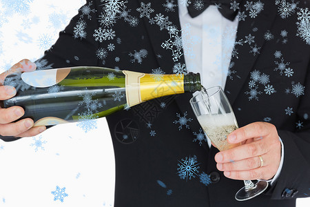 盛装打扮良好的人倒香槟的复合形象长笛蓝色衣冠雪花套装下雪起泡奢华衬衫玻璃背景图片
