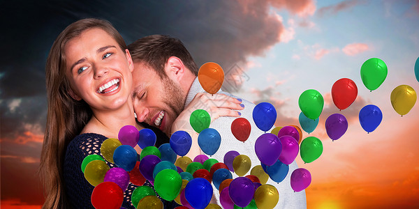 幸福的年轻夫妇交近的复合图像蓝色拥抱乐趣浪漫情人气球黑发夫妻女性天空派对高清图片素材