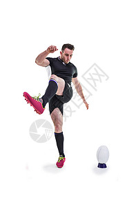 橄榄球运动员踢球黑色专注播放器运动球衣运动服体育竞技服装男人背景图片