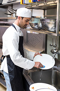 清理盘子男人做菜的英俊雇员手套厨师卫生肥皂男性职员餐厅商业制服盘子背景