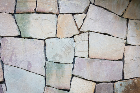 多色和多尺寸的浅色岩石墙 grunge 纹理 b建筑学风化材料乡村建筑叠石大小艺术棕色石头背景