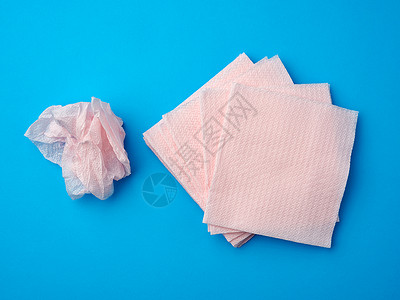 蓝色背景的粉粉粉纸面纸可支配餐巾纸背景图片