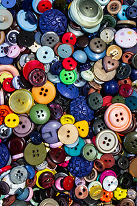 多色不同尺寸按钮的集合绿色缝纫黄色塑料纺织品裁缝工艺收藏红色圆形背景图片