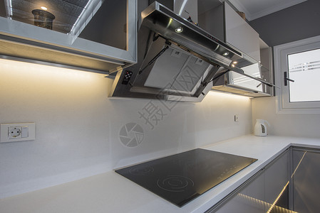豪华公寓的现代厨房炊具设计条形电磁炉奢华架子房间装饰柜台展示厅大理石排气扇背景图片