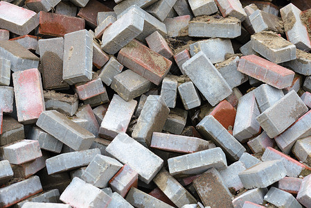 红色碎片砖块的堆积硅酸盐建筑灰色材料工业瓦砾橙子硅酸钙棕色石工背景