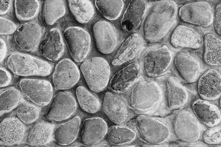 单色石墙纹理棕色材料黑色建筑建筑学卵石岩石灰色花岗岩圆形背景图片