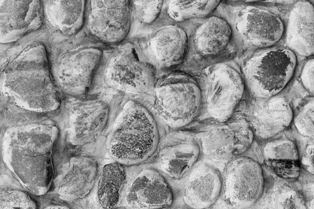 单色石墙纹理建筑花岗岩灰色材料建筑学黑色卵石棕色圆形岩石背景图片