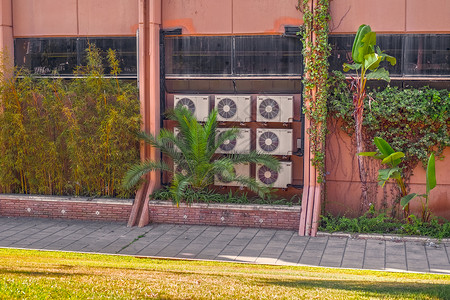 用棕榈和鲜花建筑时的工业空调机气调节器高清图片