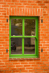红砖墙中的旧绿窗背景图片