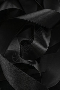 黑丝带作为背景 抽象和奢侈品牌设计曲线奢华反射黑色阴影工作室黑与白皮革丝绸桌面背景图片