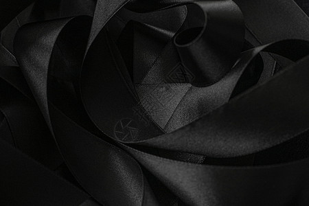黑丝带作为背景 抽象和奢侈品牌设计黑与白奢华丝绸阴影丝带工作室桌面曲线黑色皮革背景图片