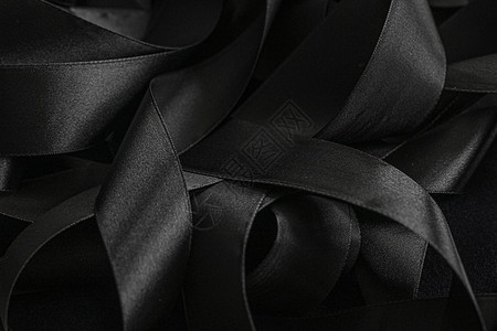 黑丝带作为背景 抽象和奢侈品牌设计曲线丝绸黑色阴影皮革桌面黑与白奢华反射丝带背景图片