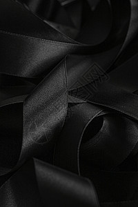 黑丝带作为背景 抽象和奢侈品牌设计桌面皮革丝带反射工作室奢华黑与白曲线黑色丝绸背景图片