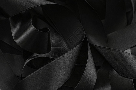 黑丝带作为背景 抽象和奢侈品牌设计丝带桌面阴影皮革黑色曲线奢华工作室黑与白丝绸背景图片