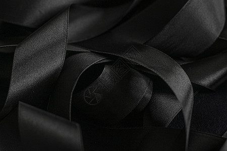 黑丝带作为背景 抽象和奢侈品牌设计奢华皮革丝带丝绸桌面曲线阴影黑与白反射工作室背景图片
