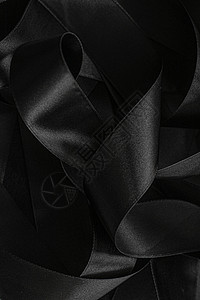 黑丝带作为背景 抽象和奢侈品牌设计桌面工作室黑与白丝带奢华反射曲线丝绸阴影皮革背景图片