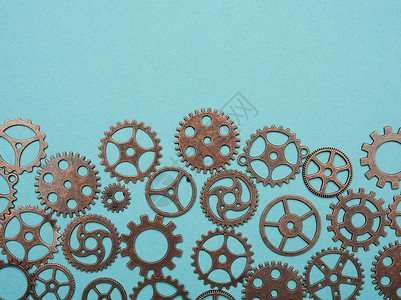 蓝色背景上各种铜齿状铜车轮青铜工程蒸汽圆形齿轮工业机器引擎圆圈背景图片