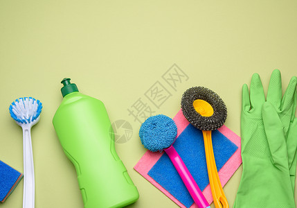 用于清洁的绿色塑料瓶和橡胶手套刷子高清图片素材