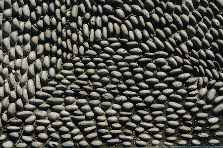 小鹅卵石的背景纹理铺路鹅卵石石头灰色岩石卵石矿物材料路面墙纸背景图片