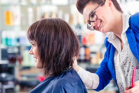 理发师在店里剪妇女头发女士剪刀梳子刘海职业沙龙理发店造型师发型工作美丽的高清图片素材