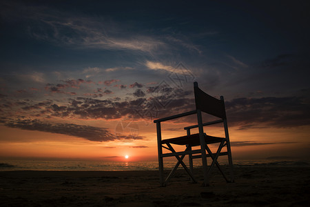 冬季海季节日落阳光天空季节性海岸椅子地平线旅行太阳背景图片
