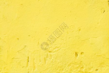 一块旧墙的碎片 上面有粗糙明亮的黄灰石膏背景图片